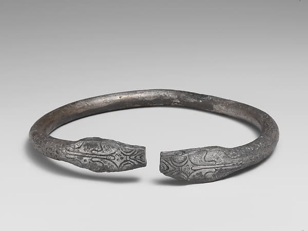 Pair of silver bracelets ending in snake's heads