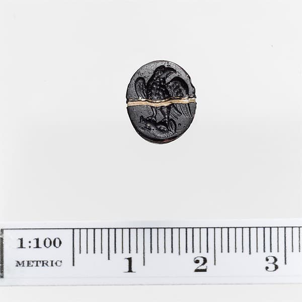 Opaque black glass ring stone with a white band