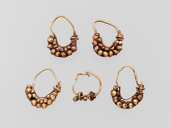 Five gold earrings with spherical elements