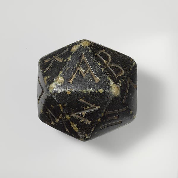 Greenstone polyhedron inscribed with letters of the Greek alphabet