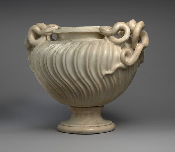 Marble strigilated vase with snake handles