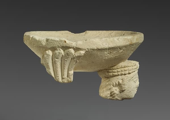 Limestone fragment of a sphinx supporting an incense burner