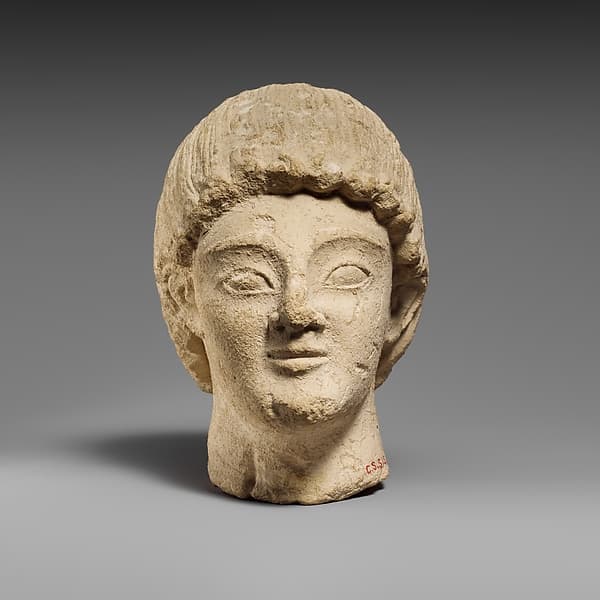 Limestone head of a beardless male votary