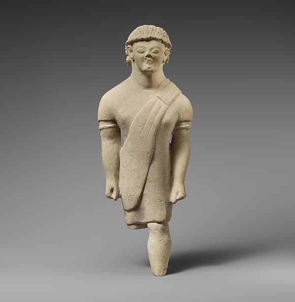 Limestone statuette of a beardless male votary in Greek dress