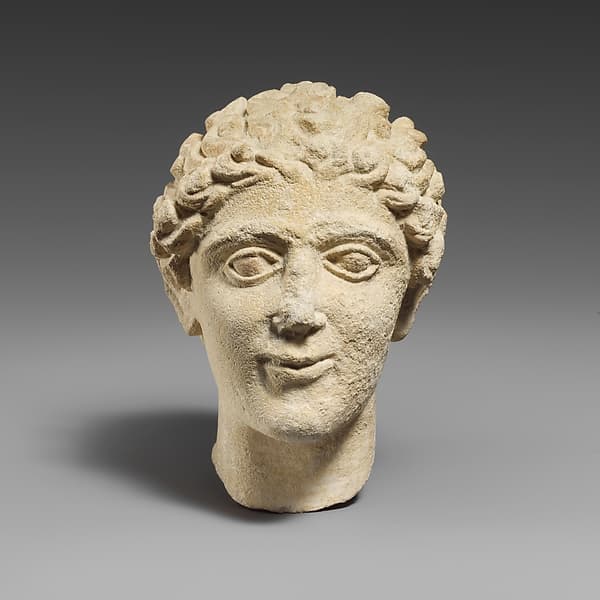 Limestone head of a beardless male votary