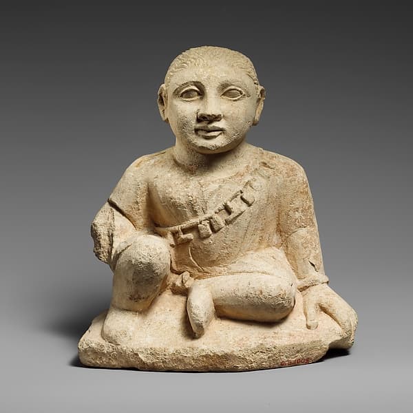 Limestone statuette of a temple boy