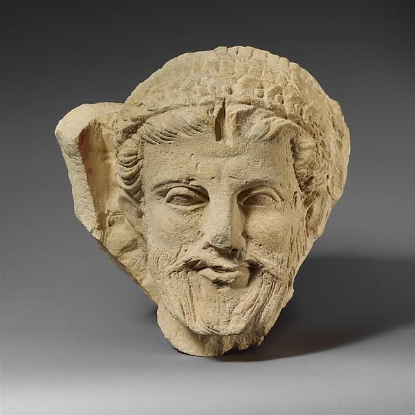 Limestone head of a bearded man from a funerary stele