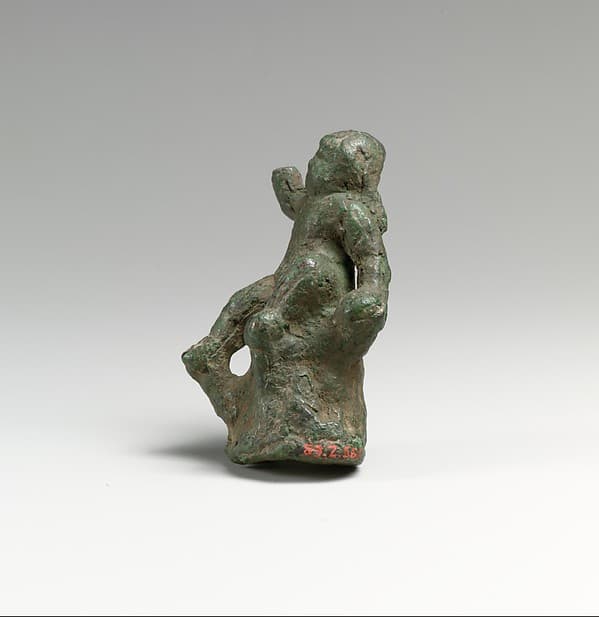 Bronze statuette of Eros seated on a rock