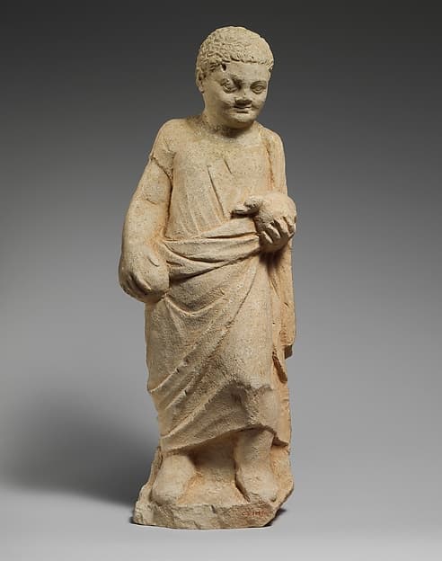 Limestone statuette of a boy holding a duck