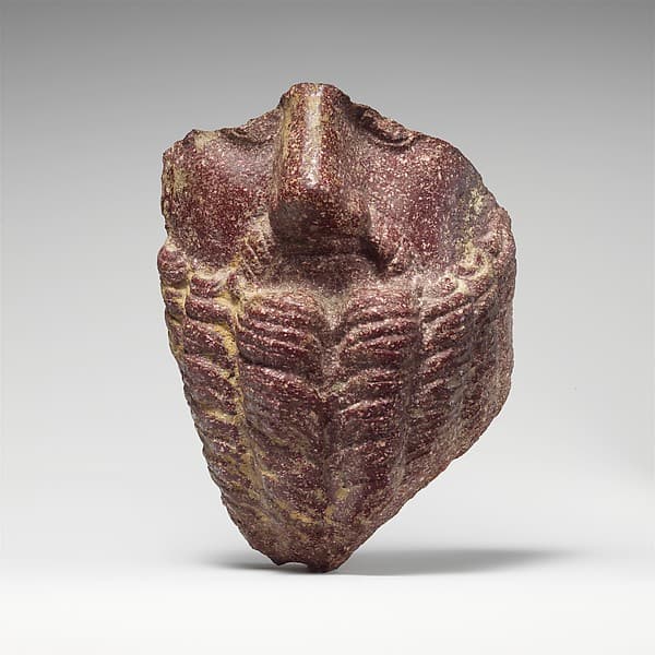Fragmentary porphyry head of a bearded man