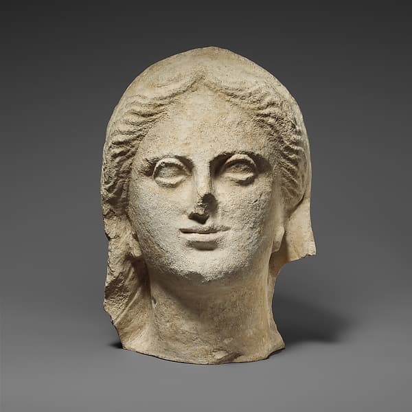 Limestone head of a veiled female votary