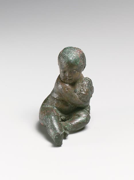 Bronze statuette of a child with a bunch of grapes