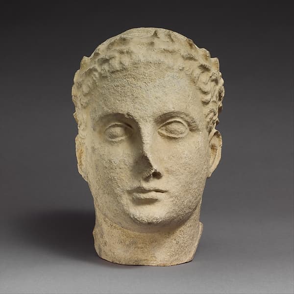 Limestone head of beardless male votary