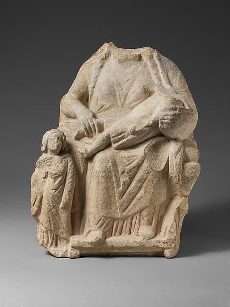 Seated limestone kourotrophos with another child standing
