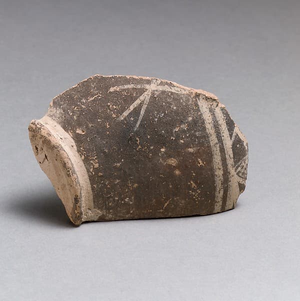 Terracotta base of a small vase with linear decoration