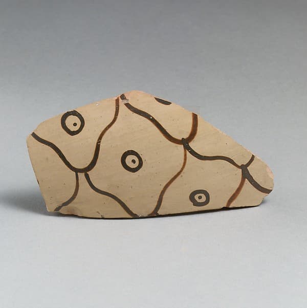 Terracotta vessel fragment with net pattern and dots within circles