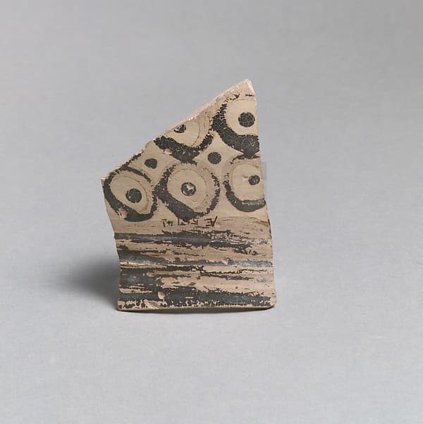 Terracotta rim from a vase with bands and dots in circles