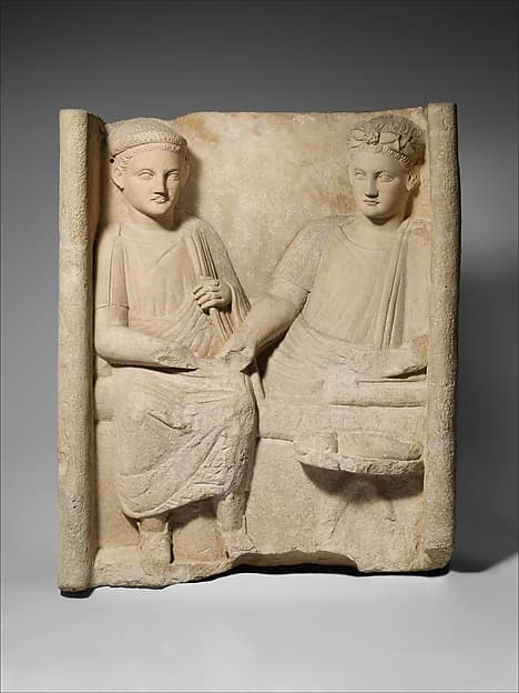 Limestone funerary stele with banquet scene