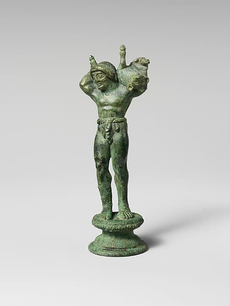 Bronze statuette of a youth carrying a pig