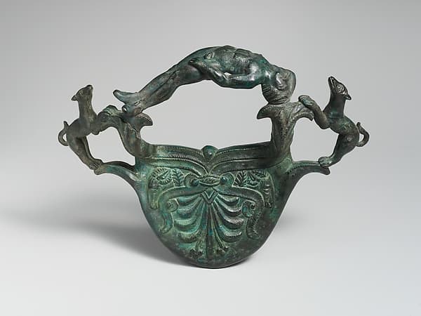 Bronze handle with dogs flanking a reclining youth