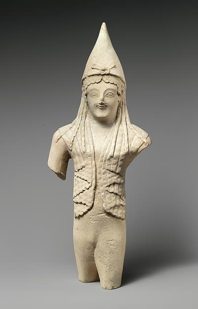 Limestone statuette of a youthful votary wearing a pointed cap