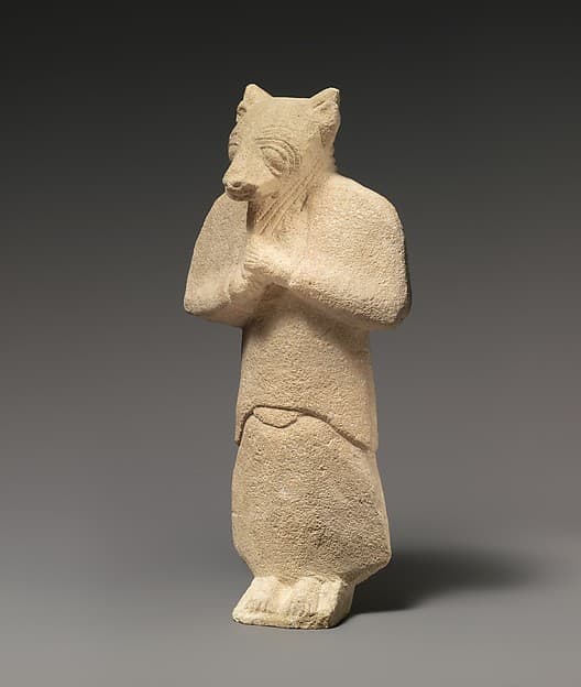 Limestone figure wearing a mask