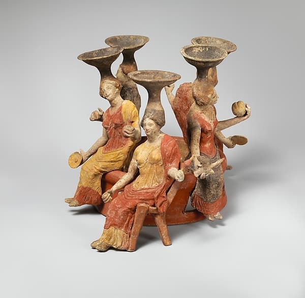 Terracotta group of women seated around a well head
