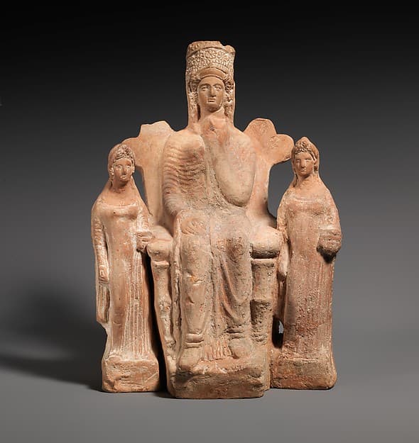 Terracotta statuette of an enthroned goddess between two attendants