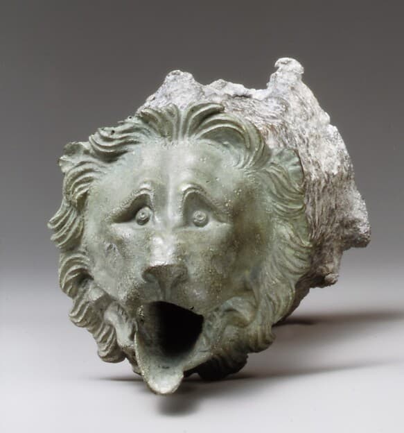 Bronze water spout with lion mask (one of a a pair)