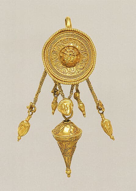 Gold disk earring with a female head and cone pendants