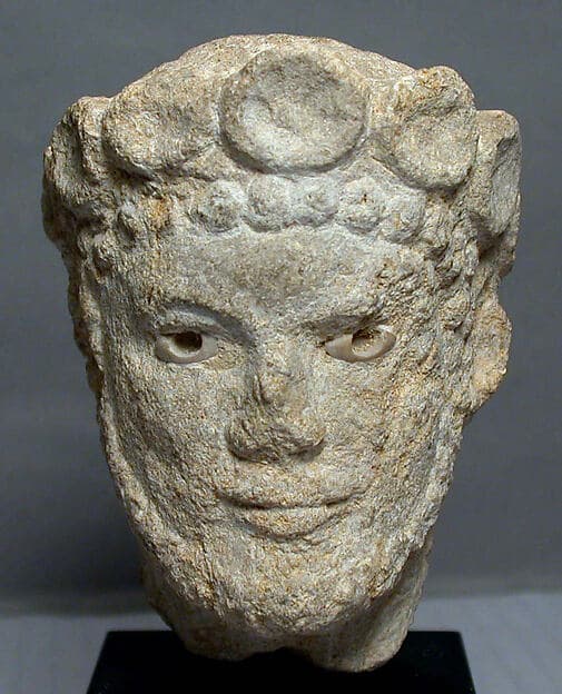 Limestone head of a bearded man