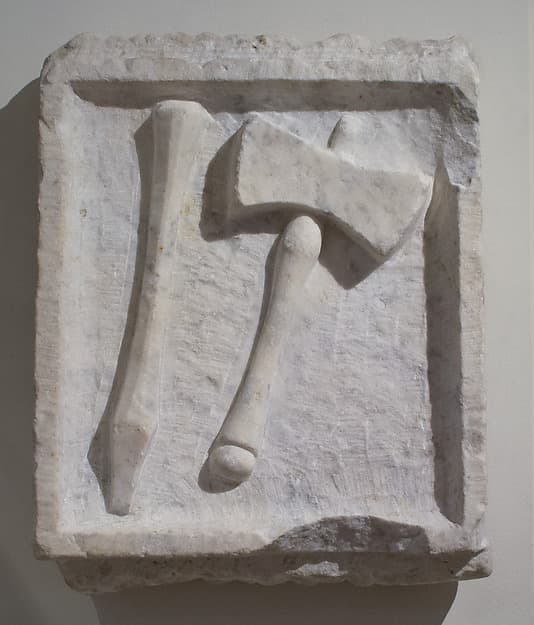 Marble relief of a chisel and mallet