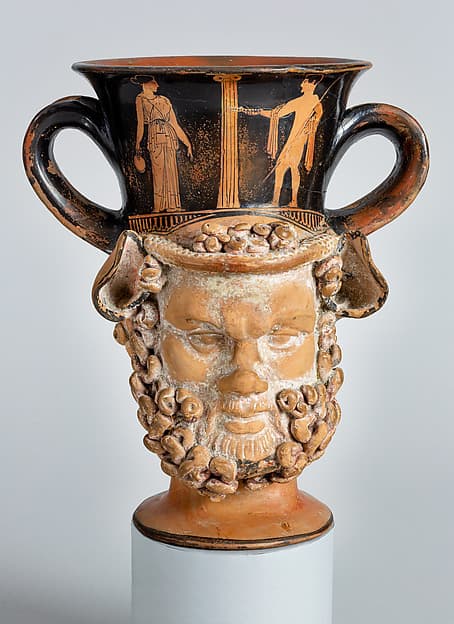 Terracotta kantharos (drinking cup with two vertical handles): heads of a satyr and a woman, by Aison