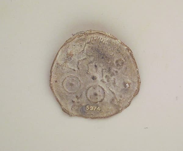 Lead votive roundel with table offerings