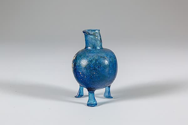 Glass bottle with three feet
