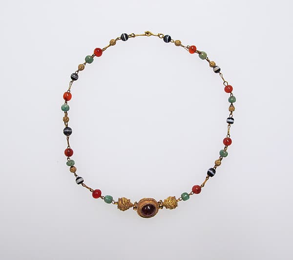 Gold, emerald, carnelian, banded onyx, and garnet necklace
