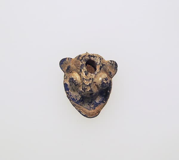 Glass pendant in the form of a demonic mask