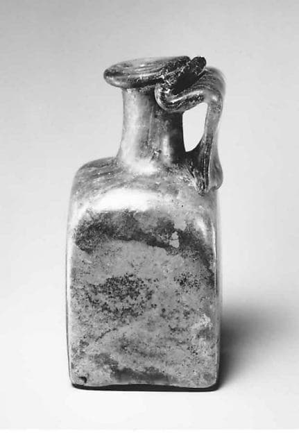 Glass square bottle with base inscription