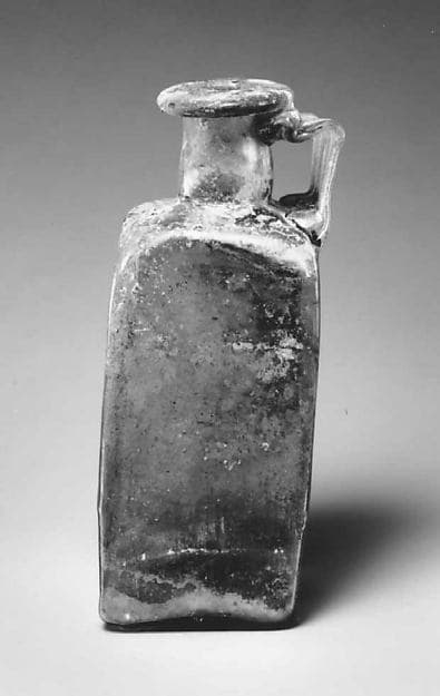 Glass square bottle with base inscription