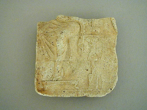 Plaster relief fragment with a male figure on a throne