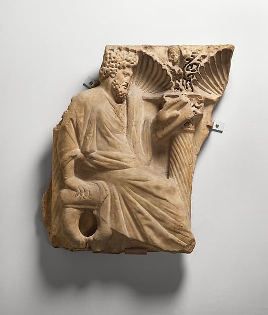 Fragment of a Sarcophagus with a Seated Figure