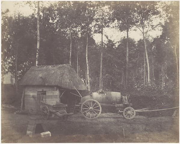 Charette devant l'entrée d'un abri au toit de chaume, by Unknown