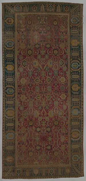 Indo-Persian carpet with repeat pattern of vine scrolls and palmettes